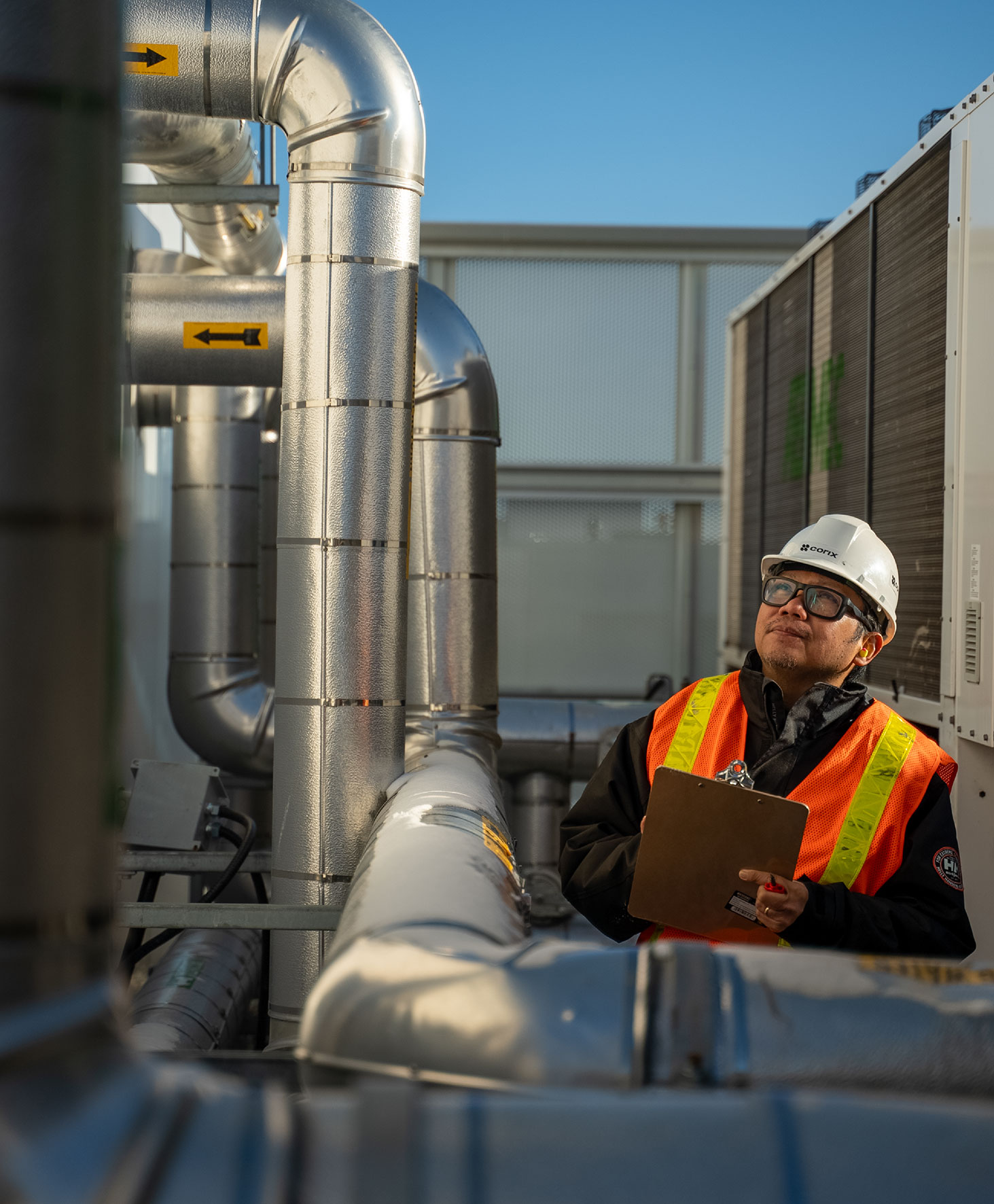 construction worker inspecting a pipe